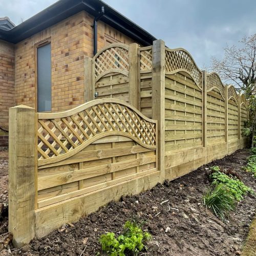 A pretty garden fence with a fence topper done by Wise Roots